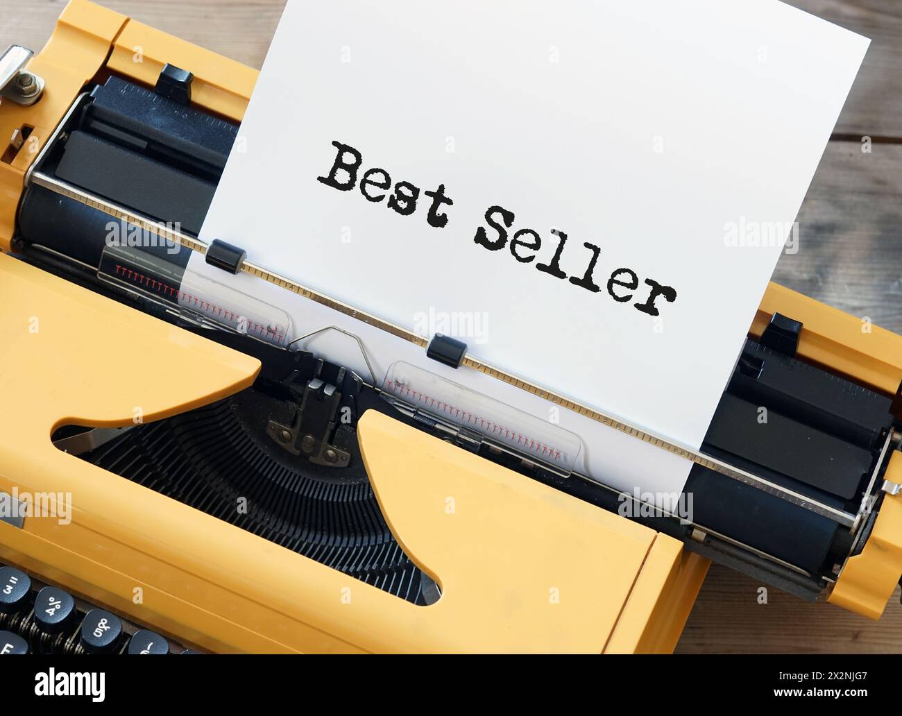 Yellow typewriter with word best seller on paper sheet Stock Photo