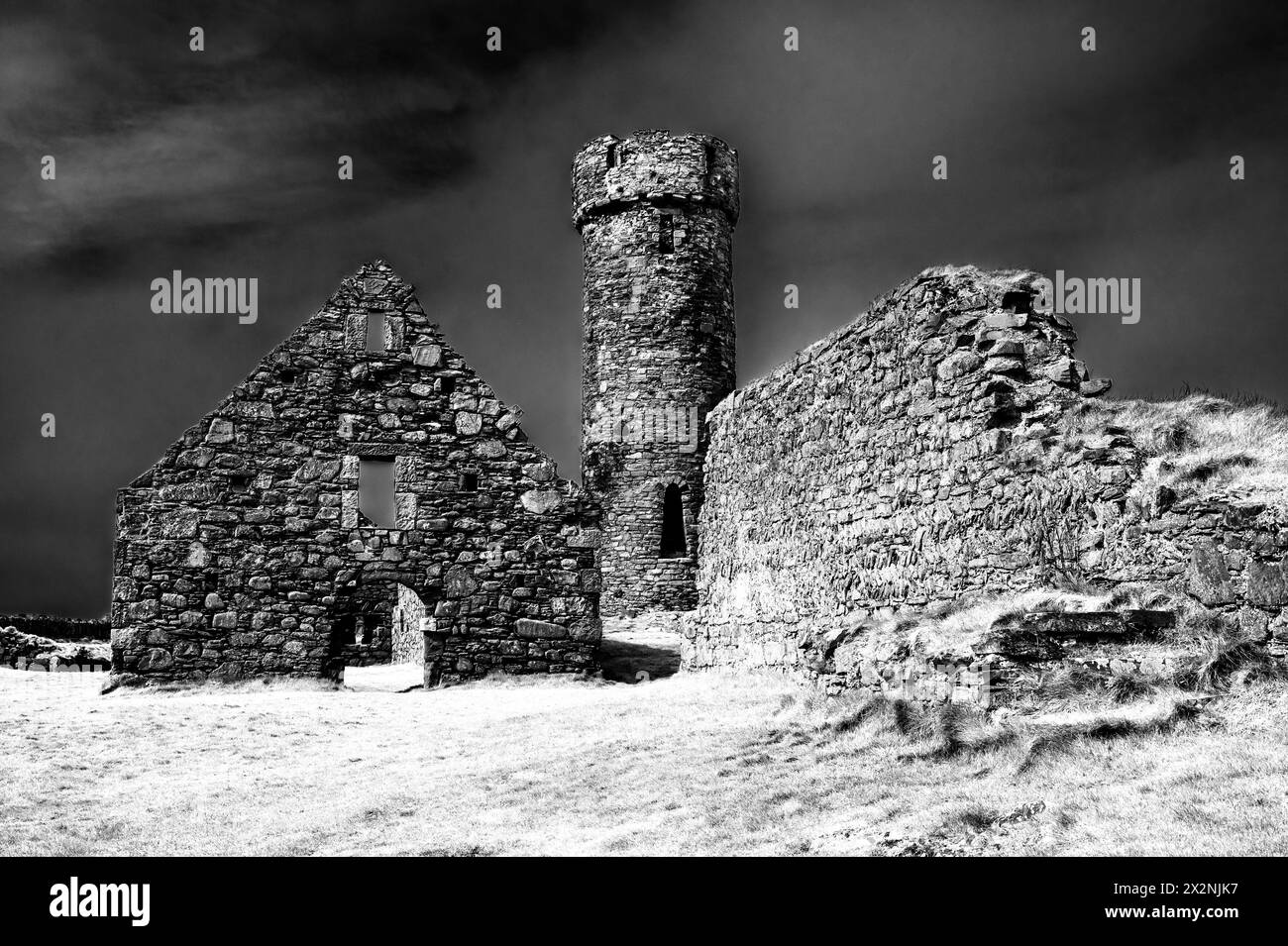 General scenic image at the historic 12th century Peel Castle and Abbey on the west coast of the Isle of Man, looking towards the defensive tower. Stock Photo