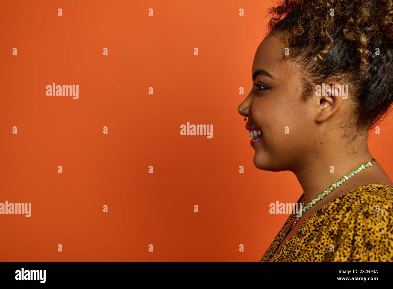A beautiful African American woman in stylish attire, beaming with joy ...