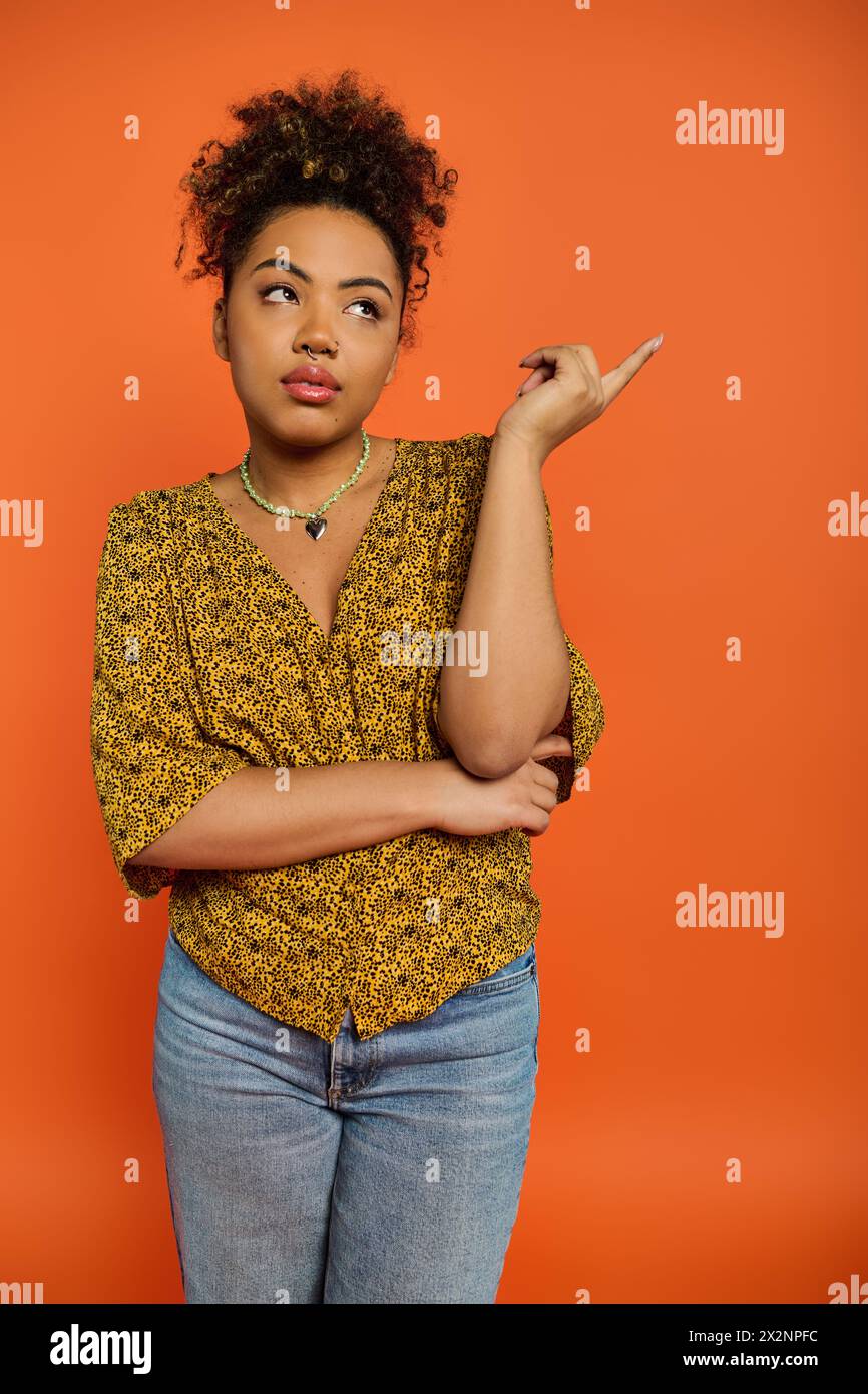 A confident African American woman in stylish attire poses with her ...