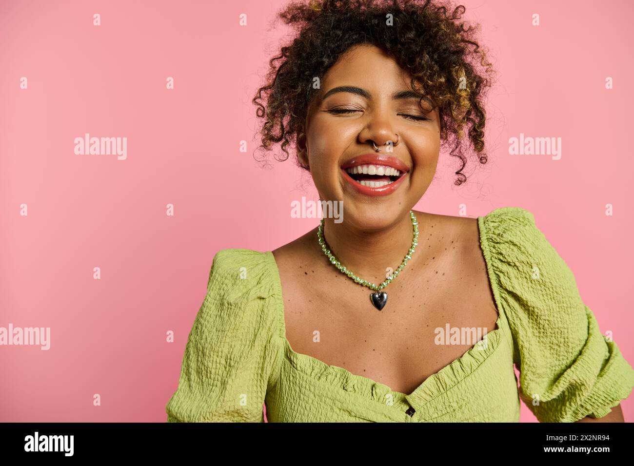 A beautiful African American woman poses in a stylish yellow dress ...