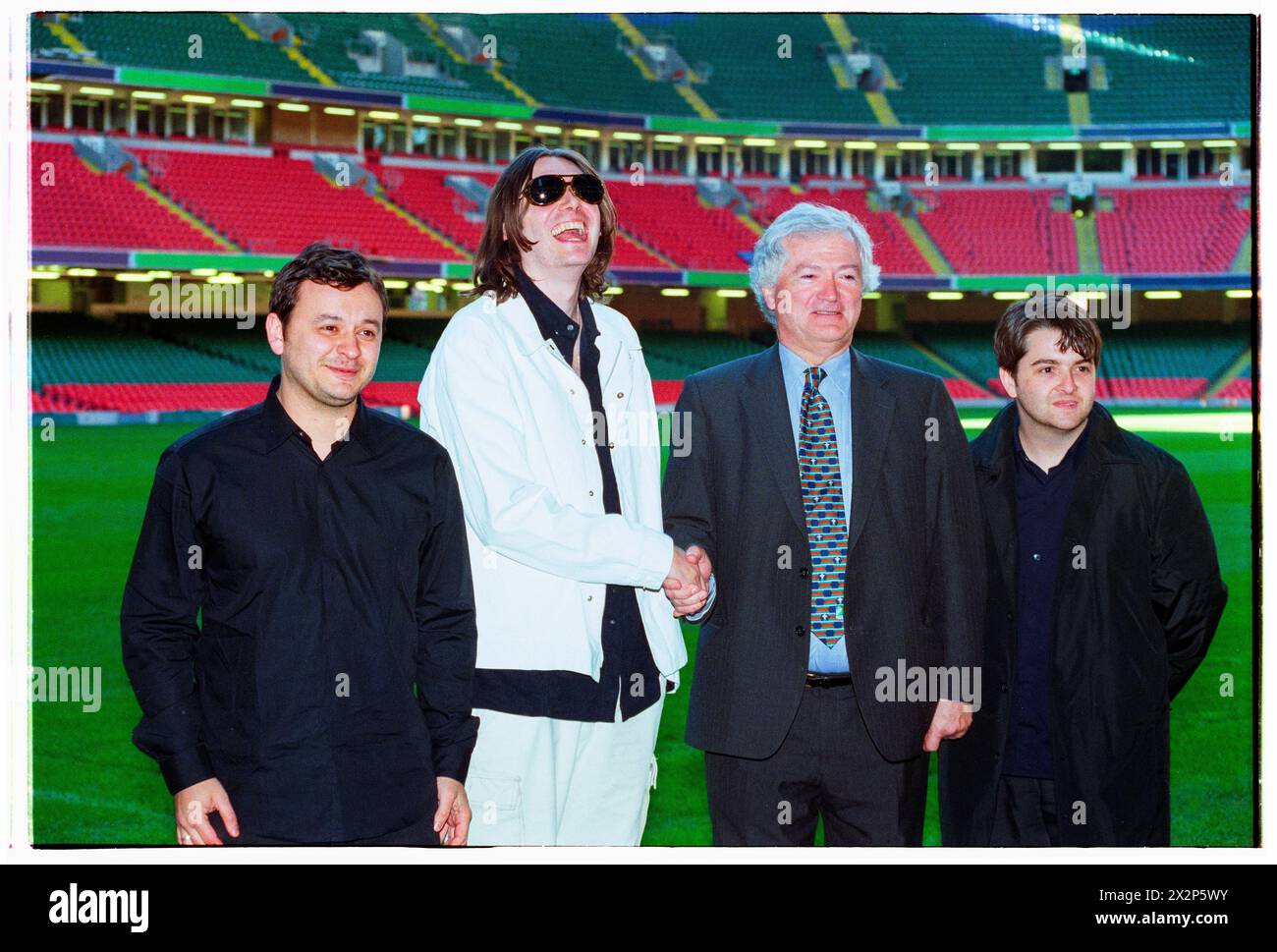 MANIC STREET PREACHERS, PRESS CONFERENCE, 1999: Welsh band Manic Street Preachers with Glanmor Griffiths  from the WRU at a Press Conference at Millennium Stadium, Cardiff Wales, UK on 1 November 1999. The band were promoting their millennium night gig in front of more than 57,000 fans on New Year's Eve 1999–2000 at the Millennium Stadium in Cardiff, called 'Leaving The 20th Century'. Photo: Rob Watkins. INFO: Manic Street Preachers, a Welsh rock band formed in 1986, emerged as icons of the '90s British music scene. Known for their politically charged lyrics and anthemic melodies, hits like 'A Stock Photo