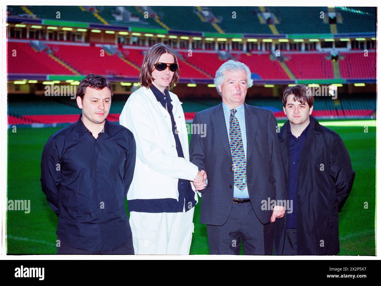 MANIC STREET PREACHERS, PRESS CONFERENCE, 1999: Welsh band Manic Street Preachers with Glanmor Griffiths  from the WRU at a Press Conference at Millennium Stadium, Cardiff Wales, UK on 1 November 1999. The band were promoting their millennium night gig in front of more than 57,000 fans on New Year's Eve 1999–2000 at the Millennium Stadium in Cardiff, called 'Leaving The 20th Century'. Photo: Rob Watkins. INFO: Manic Street Preachers, a Welsh rock band formed in 1986, emerged as icons of the '90s British music scene. Known for their politically charged lyrics and anthemic melodies, hits like 'A Stock Photo