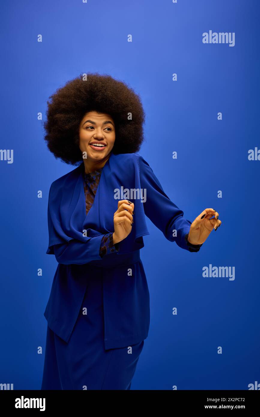 Stylish African American woman in a blue suit with curly hairdohair ...