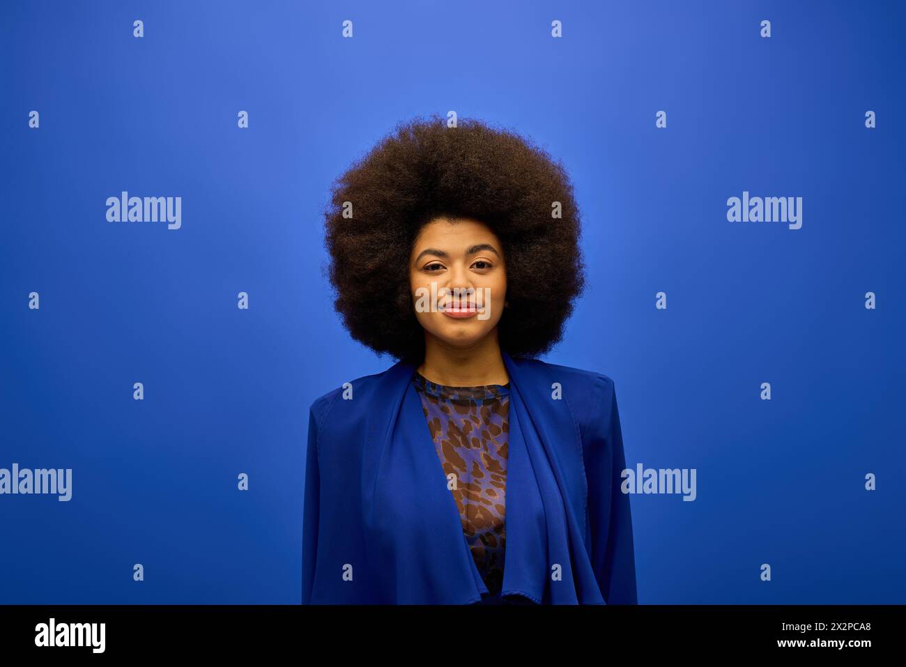 Stylish African American woman with curly hair standing confidently ...