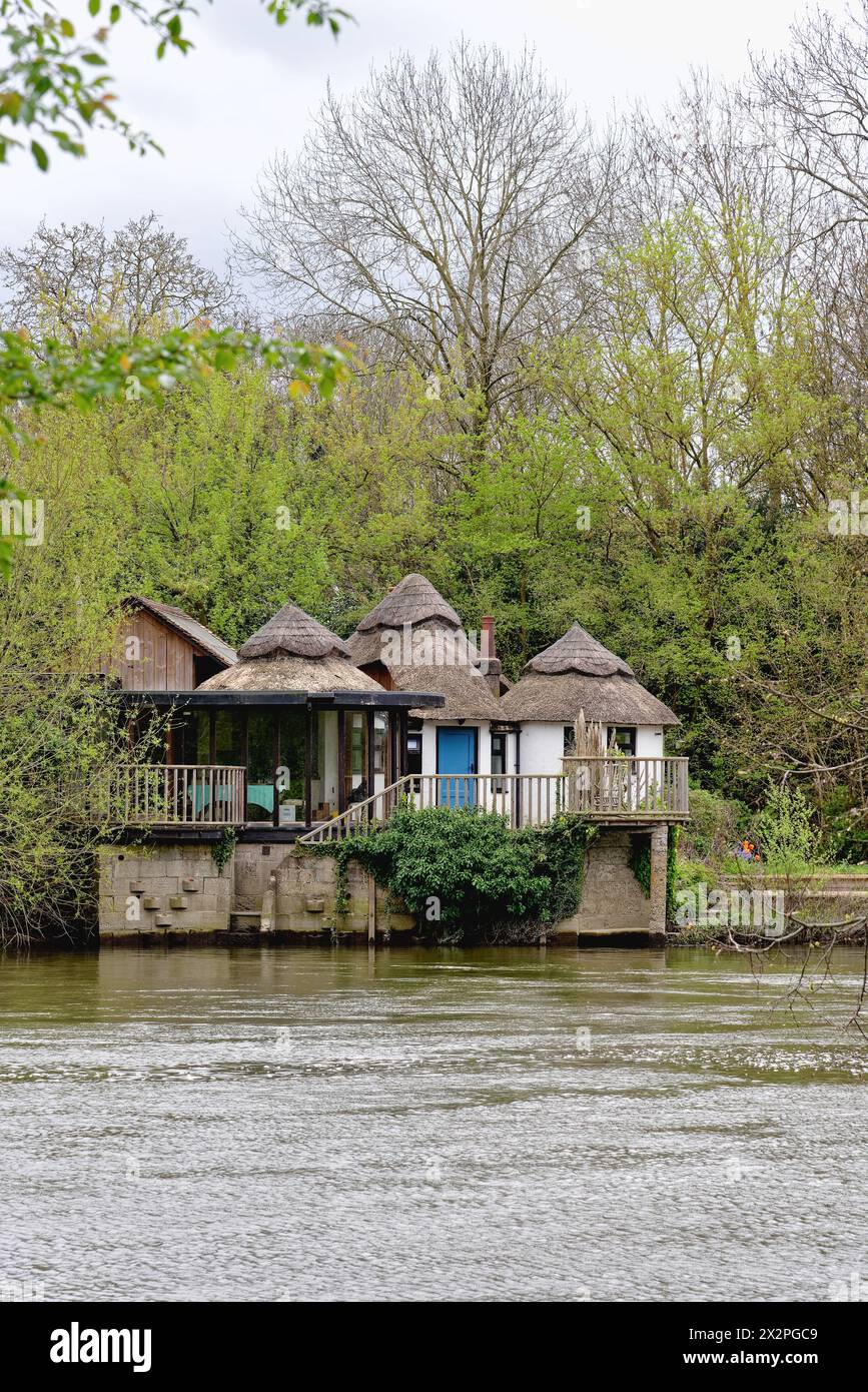 A single storey thatched cottage by the River Thames at Wraysbury Berkshire England UK Stock Photo