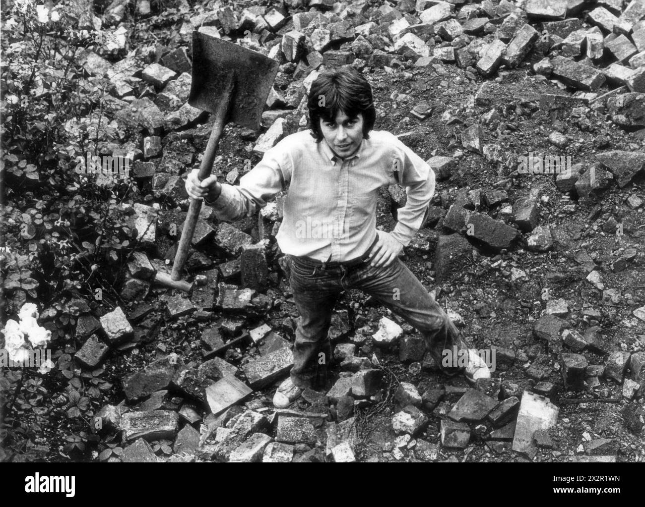 Male labourer clearing buidling rubble Britain 1972 Stock Photo Alamy