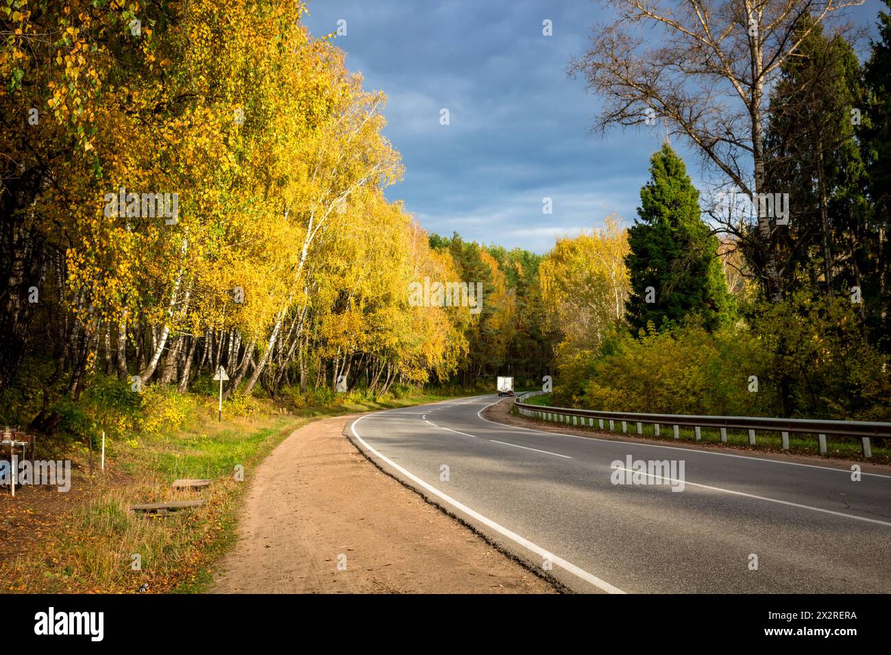 Highway with a beautiful turn. Autumn palette Stock Photo