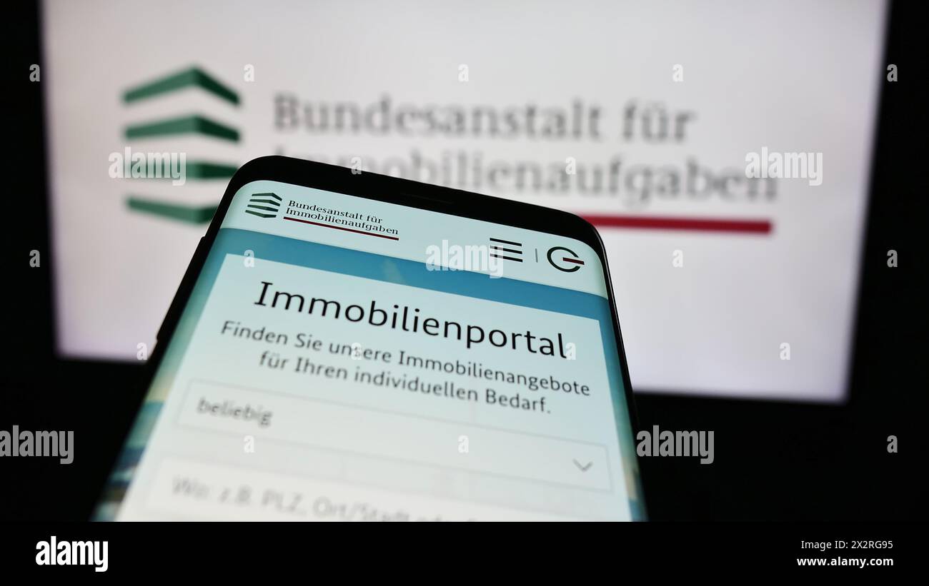 Smartphone with website of German agency Bundesanstalt für Immobilienaufgaben (BImA) in front of logo. Focus on top-left of phone display. Stock Photo