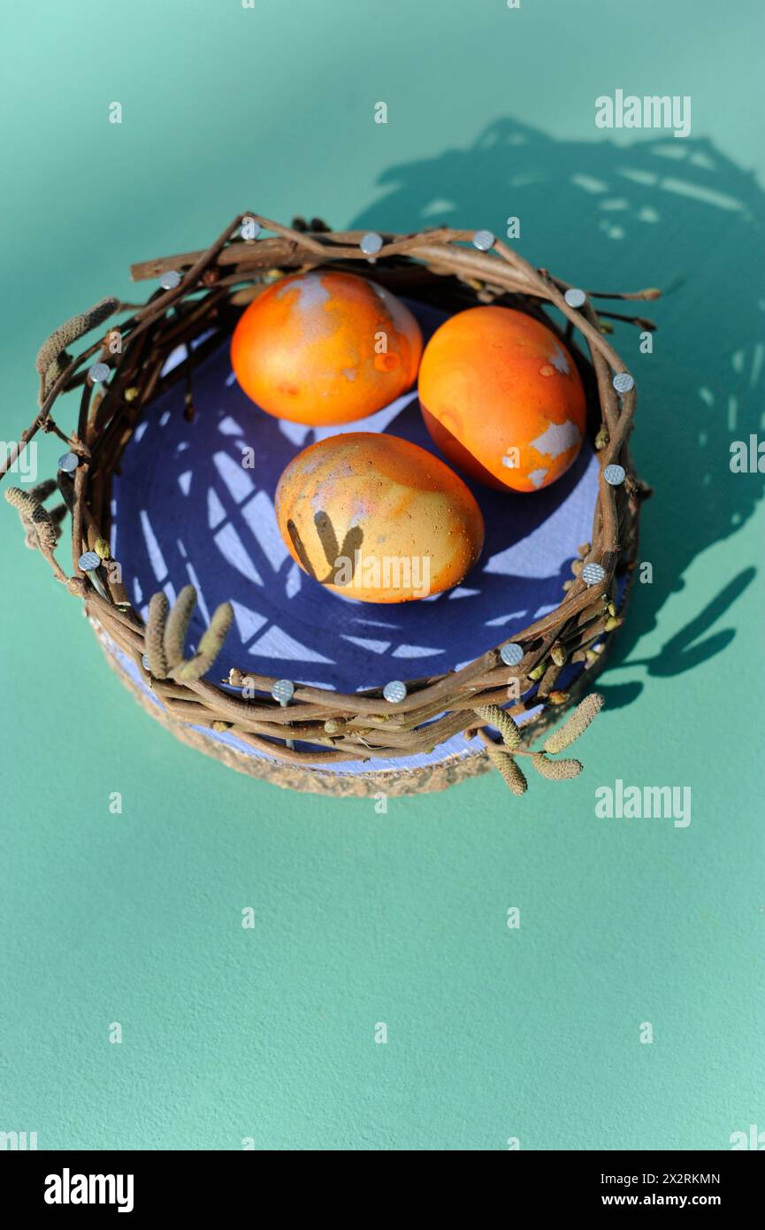 Chicken eggs in DIY decorative Easter nest Stock Photo