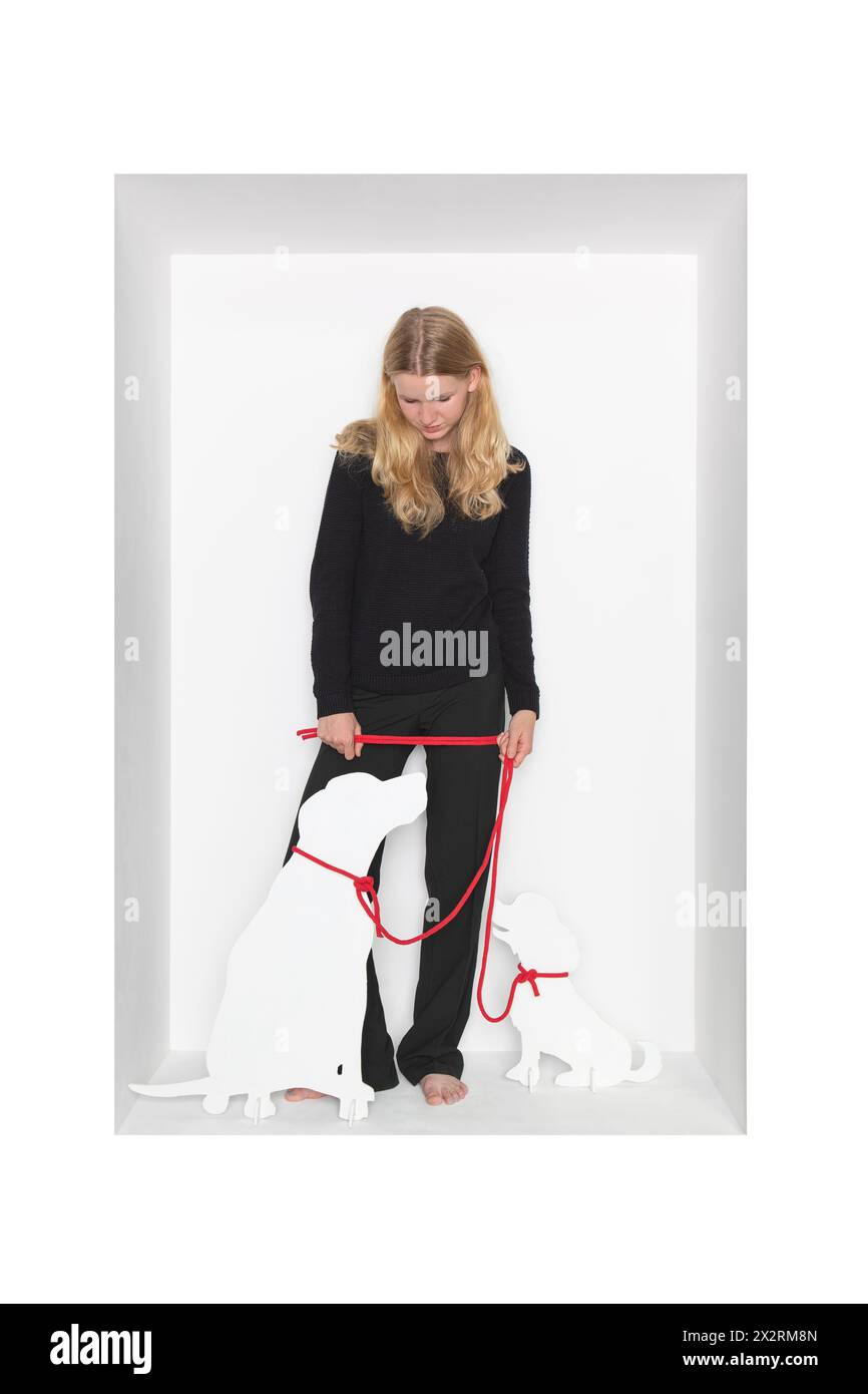 Blond girl with dog cut out standing against white background Stock Photo