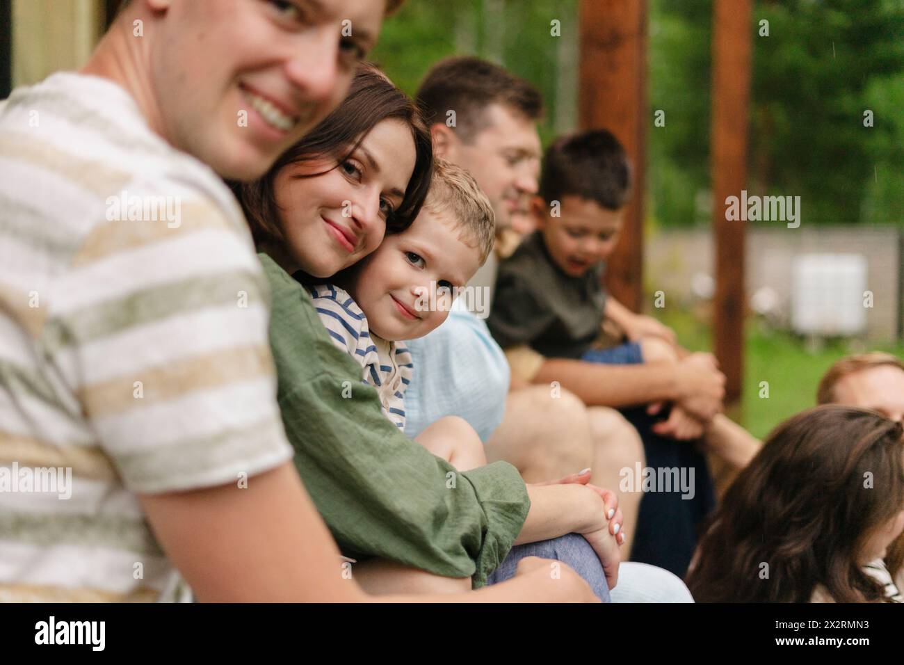 Happy family gathering with friends on summer vacation Stock Photo