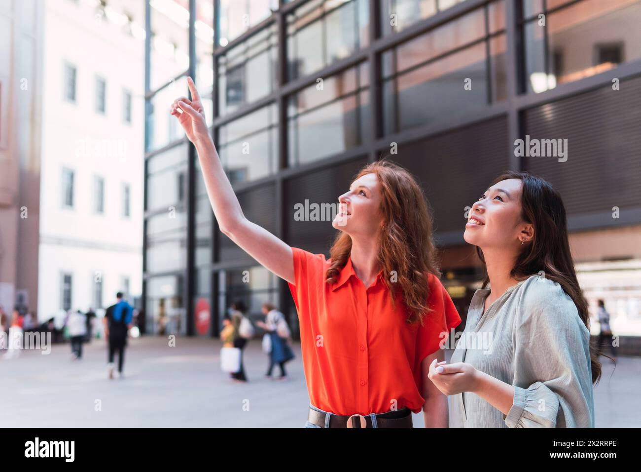 Pointing Near Asian woman pointing up showing hi-res stock photography and images - Alamy
