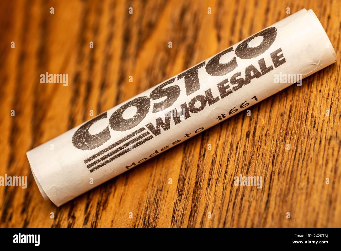 A rolled up Costco Wholesale receipt with logo Stock Photo