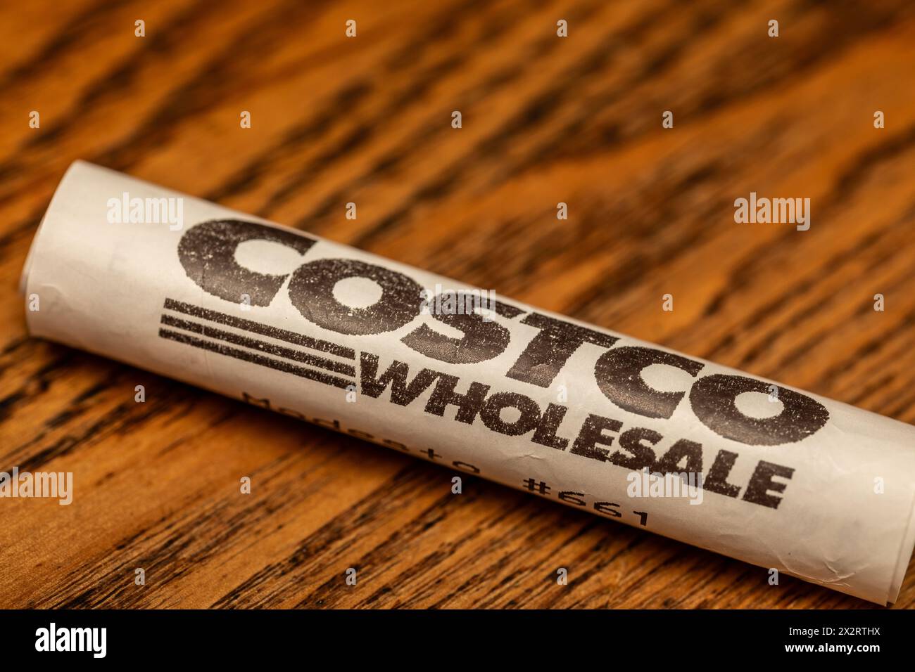 A rolled up Costco Wholesale receipt with logo Stock Photo