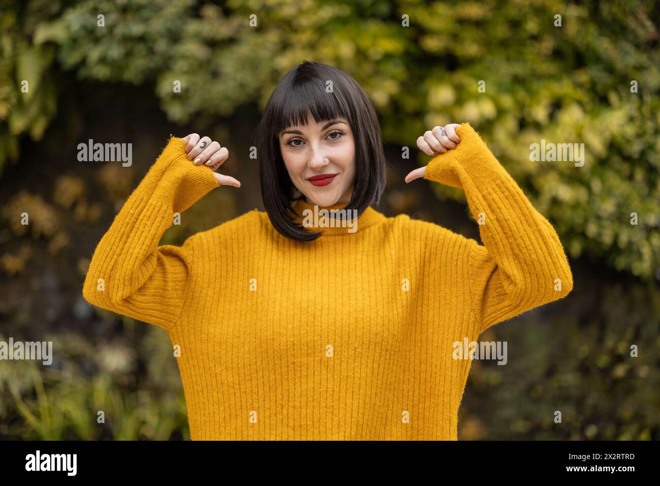 Woman in yellow sweater wearing hi-res stock photography and images - Alamy