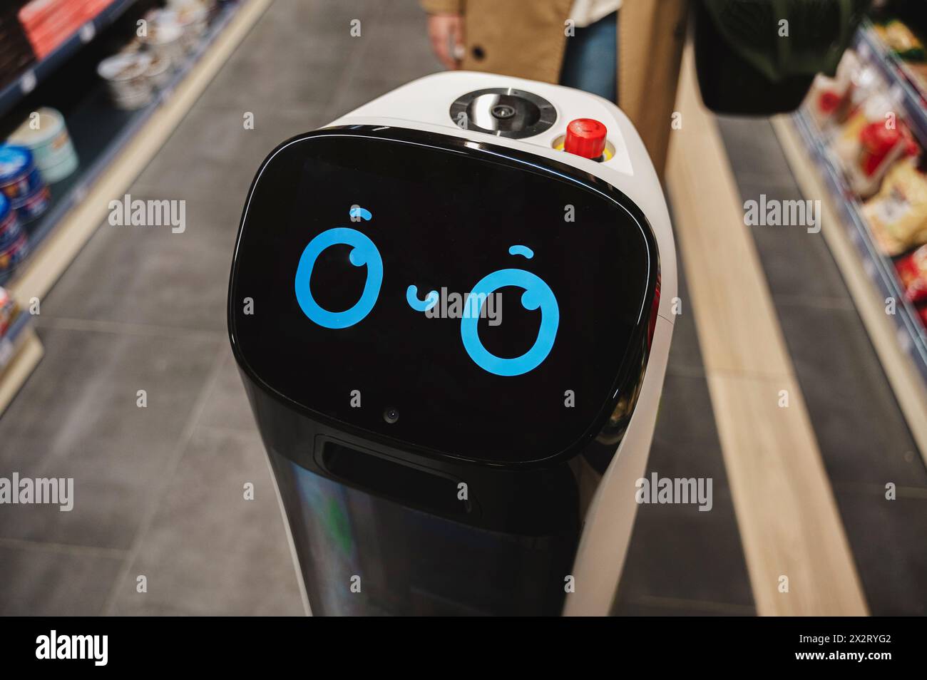 Cute robot with artificial intelligence at supermarket Stock Photo
