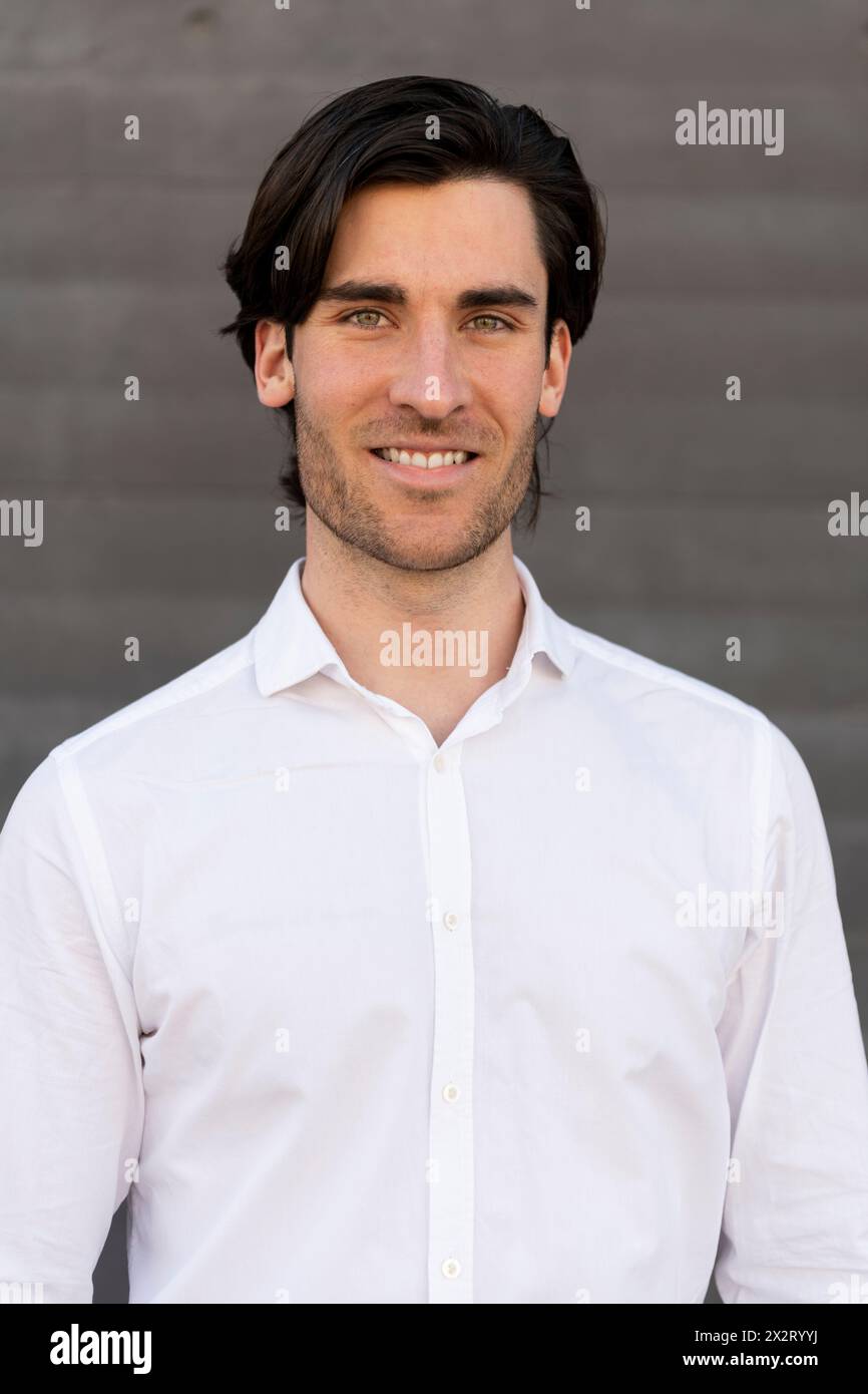 Smiling young businessman in white shirt Stock Photo
