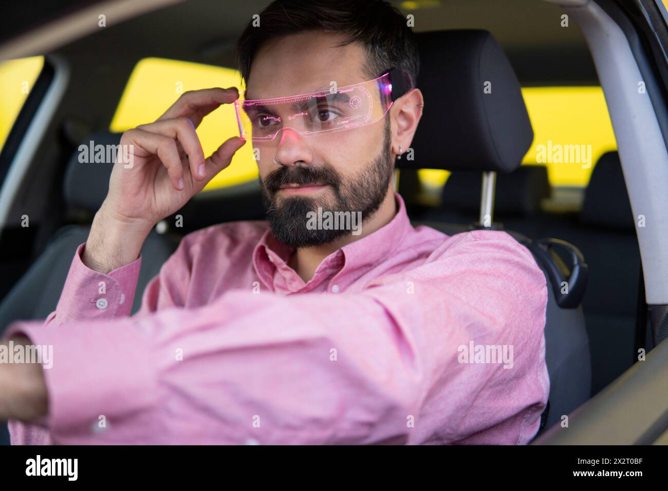 Man wearing smart glasses and sitting in car Stock Photo