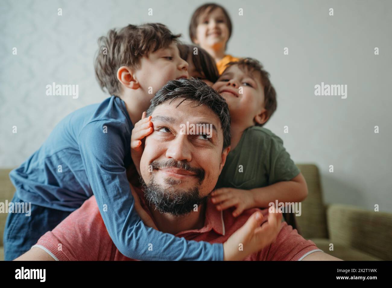 Father having fun with playful children at home Stock Photo