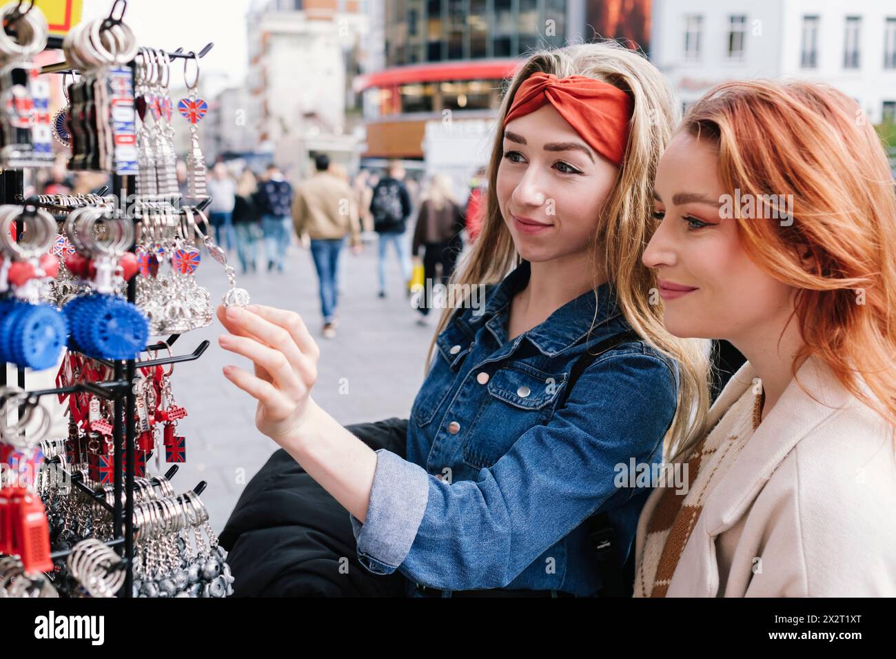 Friends shopping for key rings in London city Stock Photo