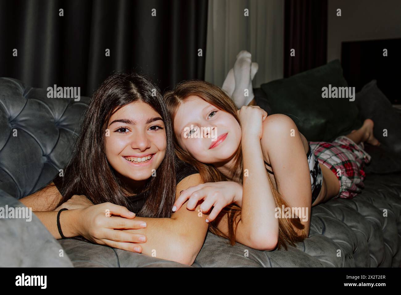 Girl lying down on sofa hi-res stock photography and images - Alamy
