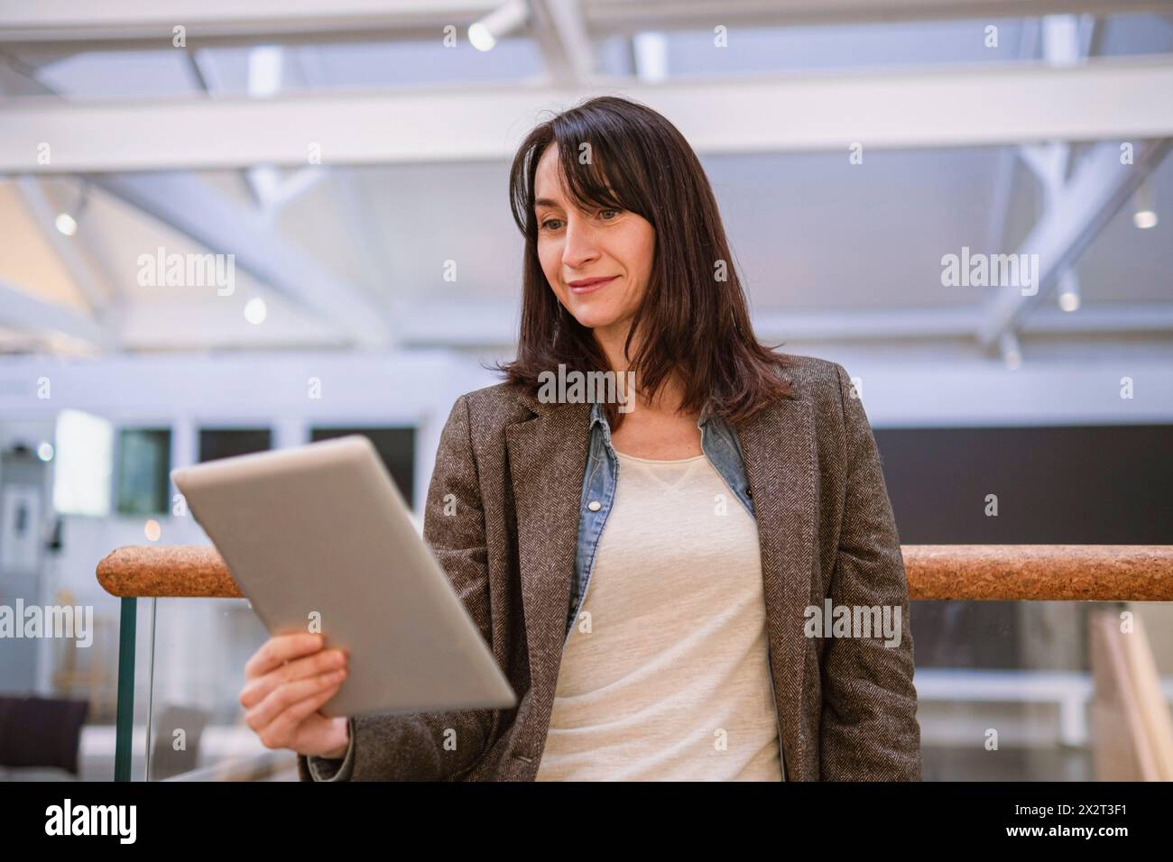 Smiling mature woman using tablet PC Stock Photo