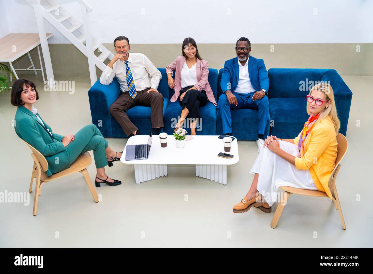Multi-ethnic business colleagues sitting together at office Stock Photo