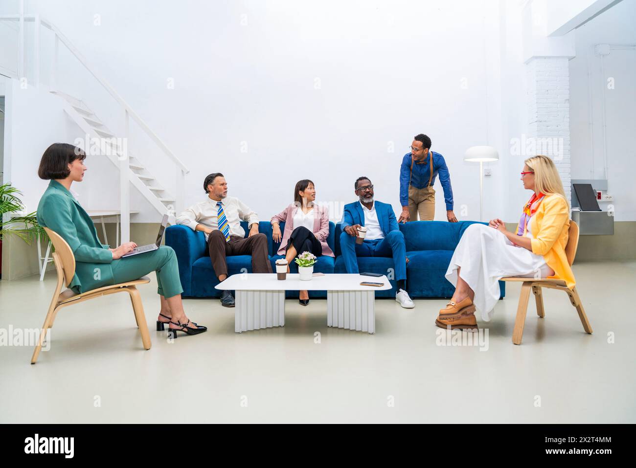Multi-ethnic corporate business team discussing with each other at office Stock Photo