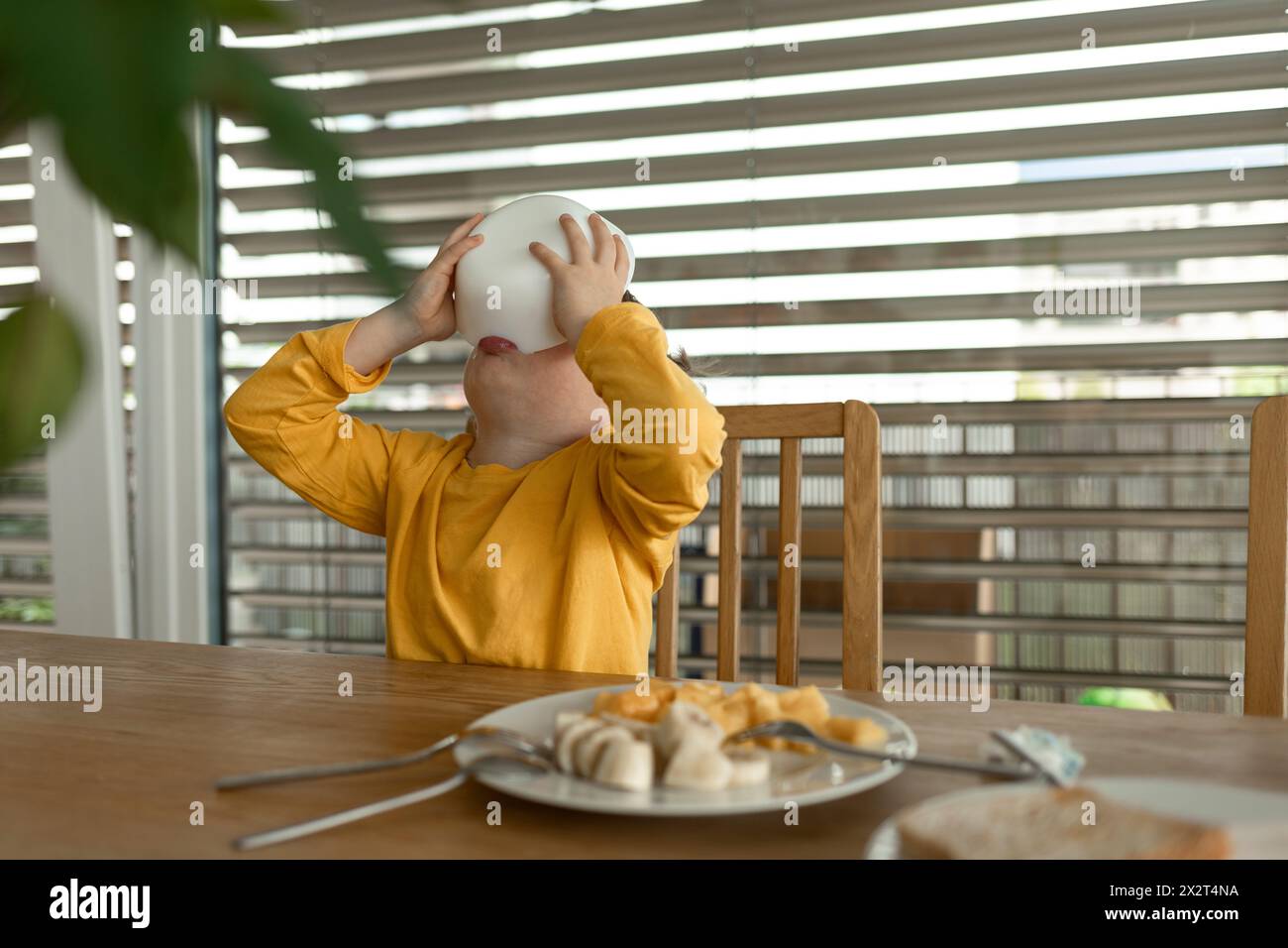 Boy sitting on the dining table hi-res stock photography and images - Alamy