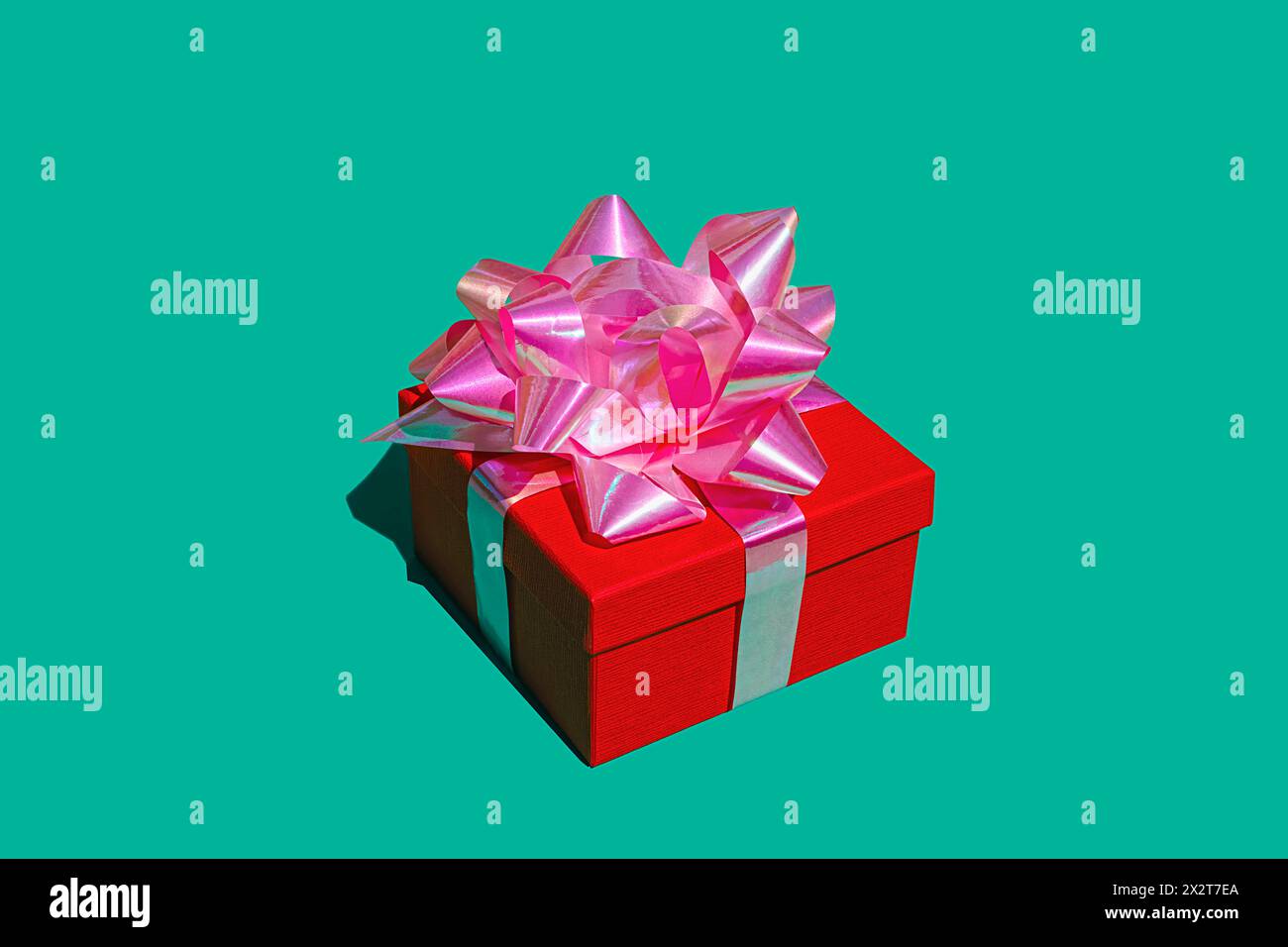 Red gift box against green background Stock Photo