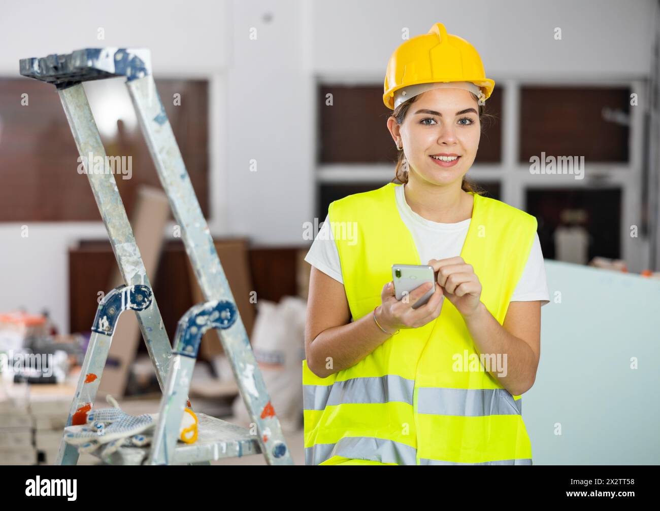 Young woman engineer using smartphone in construction site Stock Photo