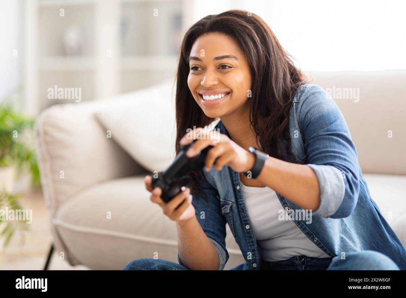 Woman on couch control hi-res stock photography and images - Alamy