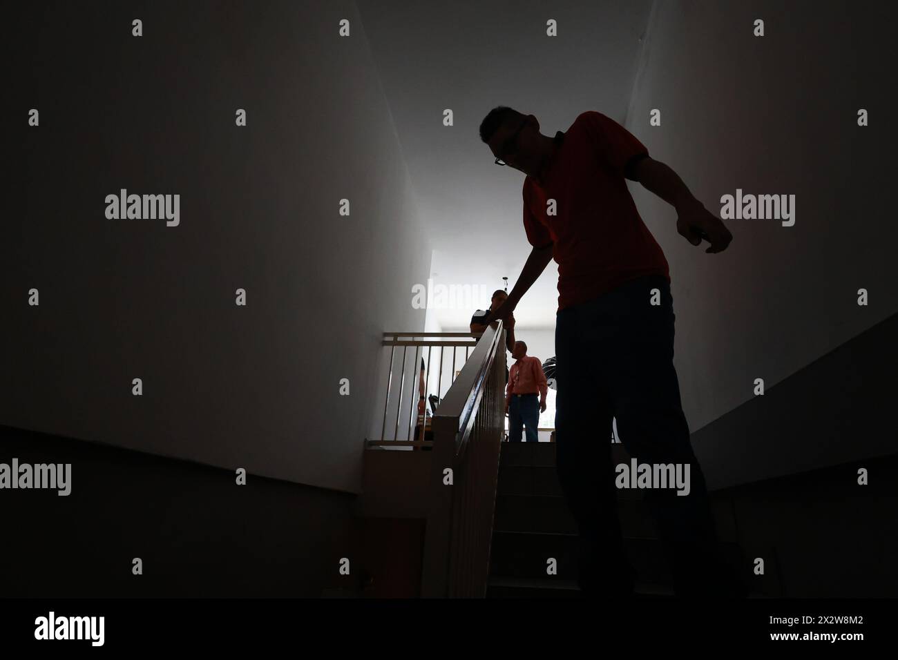 Maracay, Venezuela. 23rd Apr, 2024. Venezuelan Jeison Rodriguez (r) walks down the stairs in his house. Rodriguez has been given shoes specially made for his long feet by the German shoemaker Wessels. Credit: Jesus Vargas/dpa/Alamy Live News Stock Photo