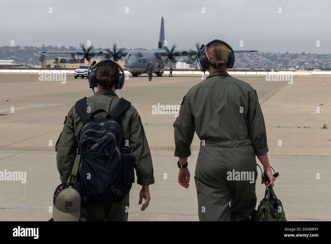 U.S. Marine Corps Capt. Olivia Bair, left, and Capt. Morgan Jones, both KC-130J Super Hercules pilots with Marine Aerial Refueler Transport Squadron (VMGR) 352, Marine Aircraft Group 11, 3rd Marine Aircraft Wing, walk toward a KC-130J Super Hercules at Naval Air Station North Island, Coronado, California, April 21, 2024.  VMGR-352 supported the San Diego Padres’ Sunday Salute to Women in the Military to honor the commitment of U.S. military service members and connect with the San Diego community. (U.S. Marine Corps photo by Lance Cpl. Nicholas Johnson) Stock Photo