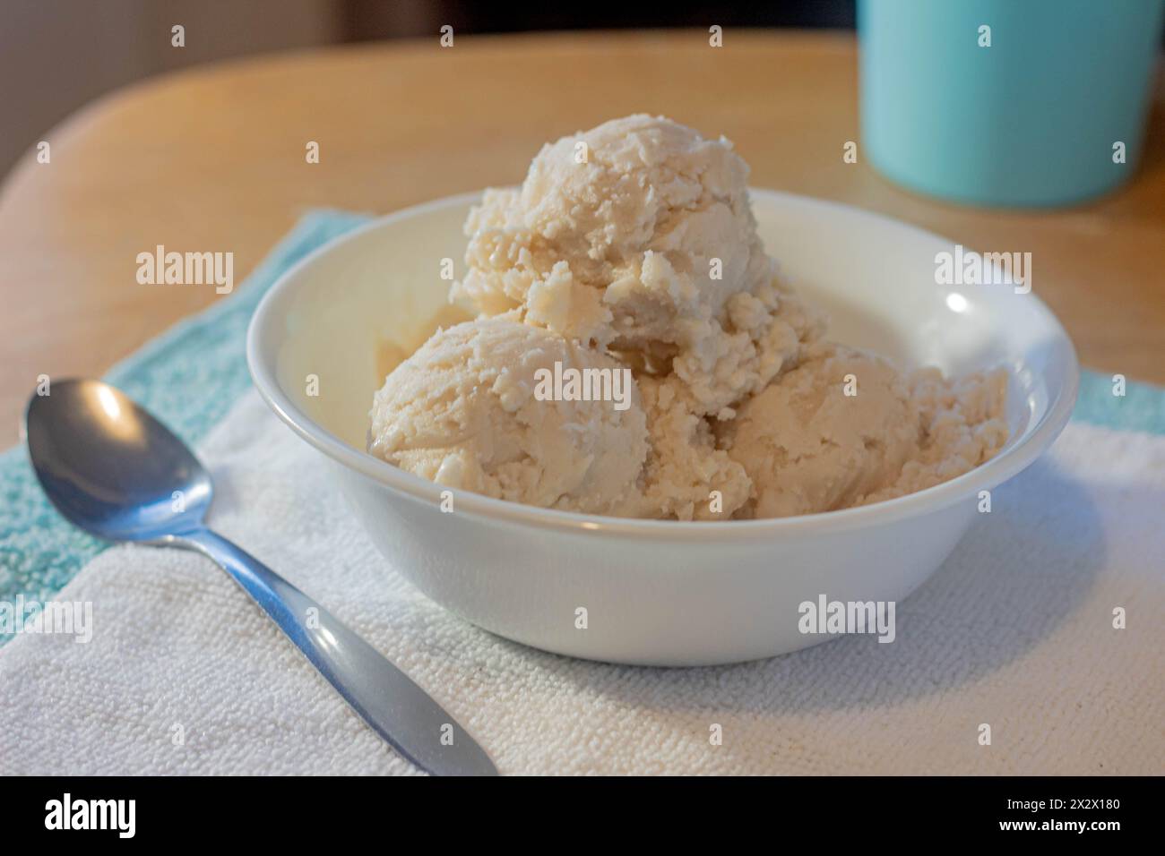 A prepared bowl of fresh, cold vanilla ice cream in the morning. Stock Photo