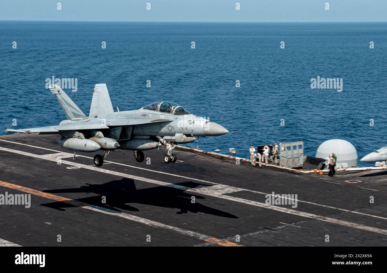 USS Theodore Roosevelt, United States. 18 April, 2024. A U.S. Navy F/A-18F Super Hornet fighter aircraft from the Black Knights of Strike Fighter Squadron 154, lands on the flight deck of the Nimitz-class aircraft carrier USS Theodore Roosevelt underway conducting routine operations, April 18, 2024 on the South China Sea.  Credit: MC3 Samuel Vazquez/U.S Navy Photo/Alamy Live News Stock Photo