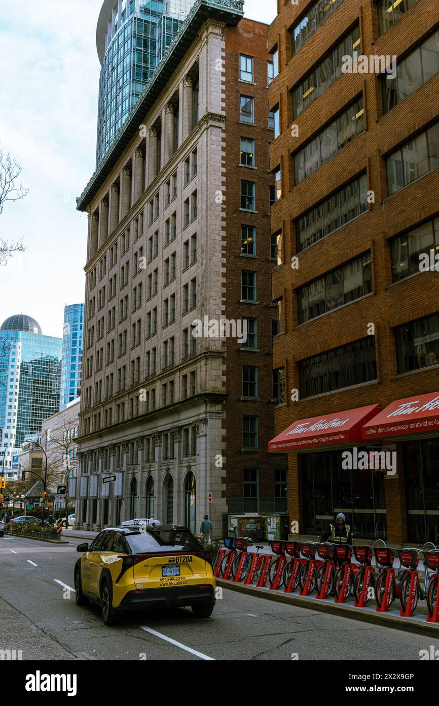 Vancouver, Canada - Feb 27 2024: A photo of two brick buildings on Hornby Street, one more classical and the other more contemporary. Stock Photo