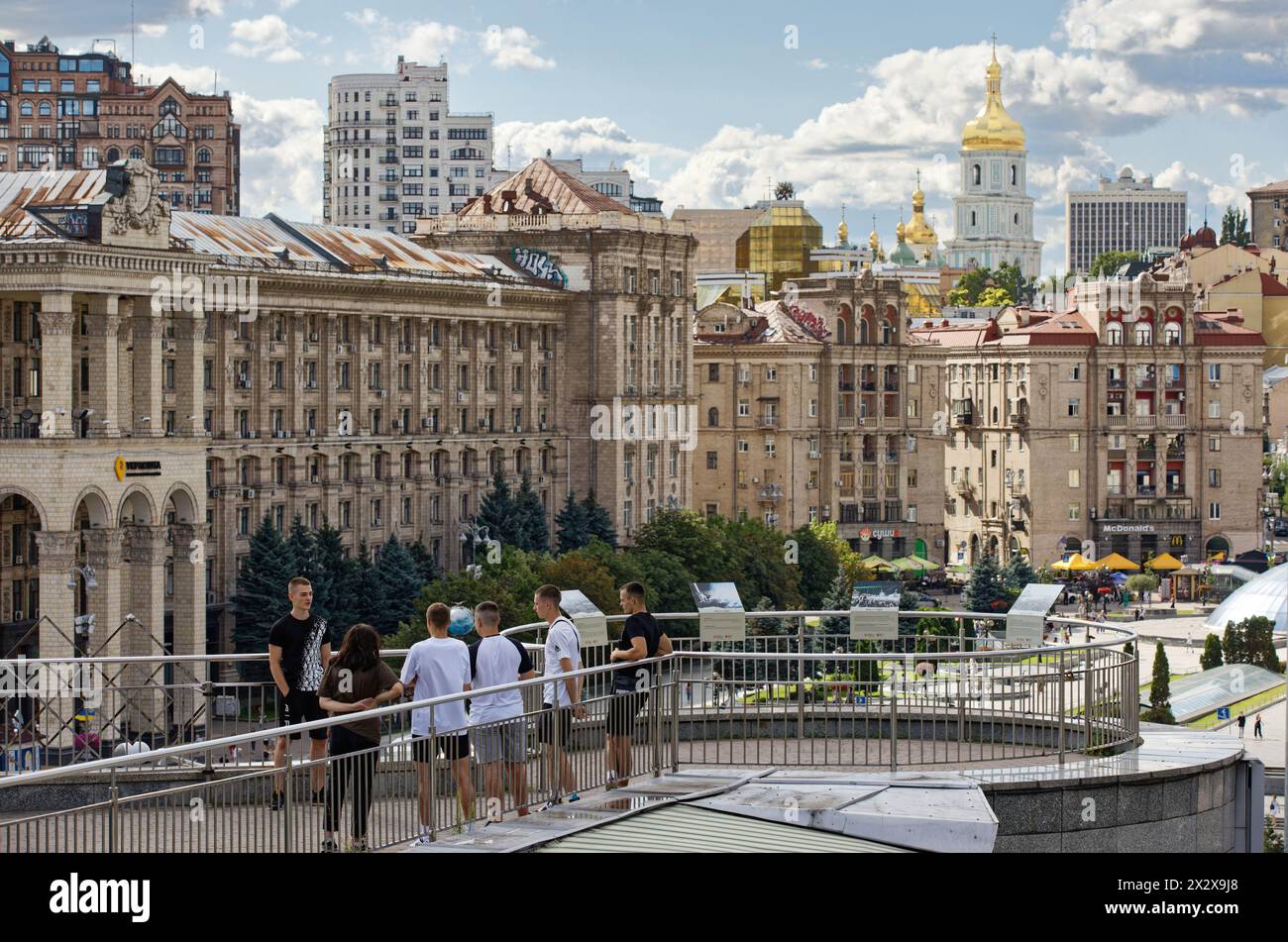 28.07.2023, Kiev, Kiev, Ukraine - View from the Maidan to the bell tower of St. Sophia Cathedral. Stalinist style buildings. A group of young people s Stock Photo