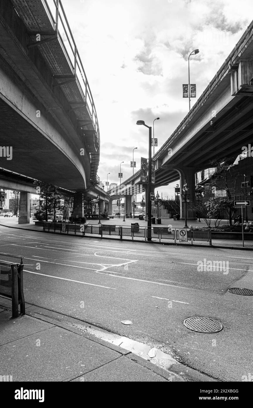 Vancouver, Canada - Mar 5 2024: A black and white view of the Dunsmuir Viaduct and the Expo Line Skytrain's tracks from street level Stock Photo