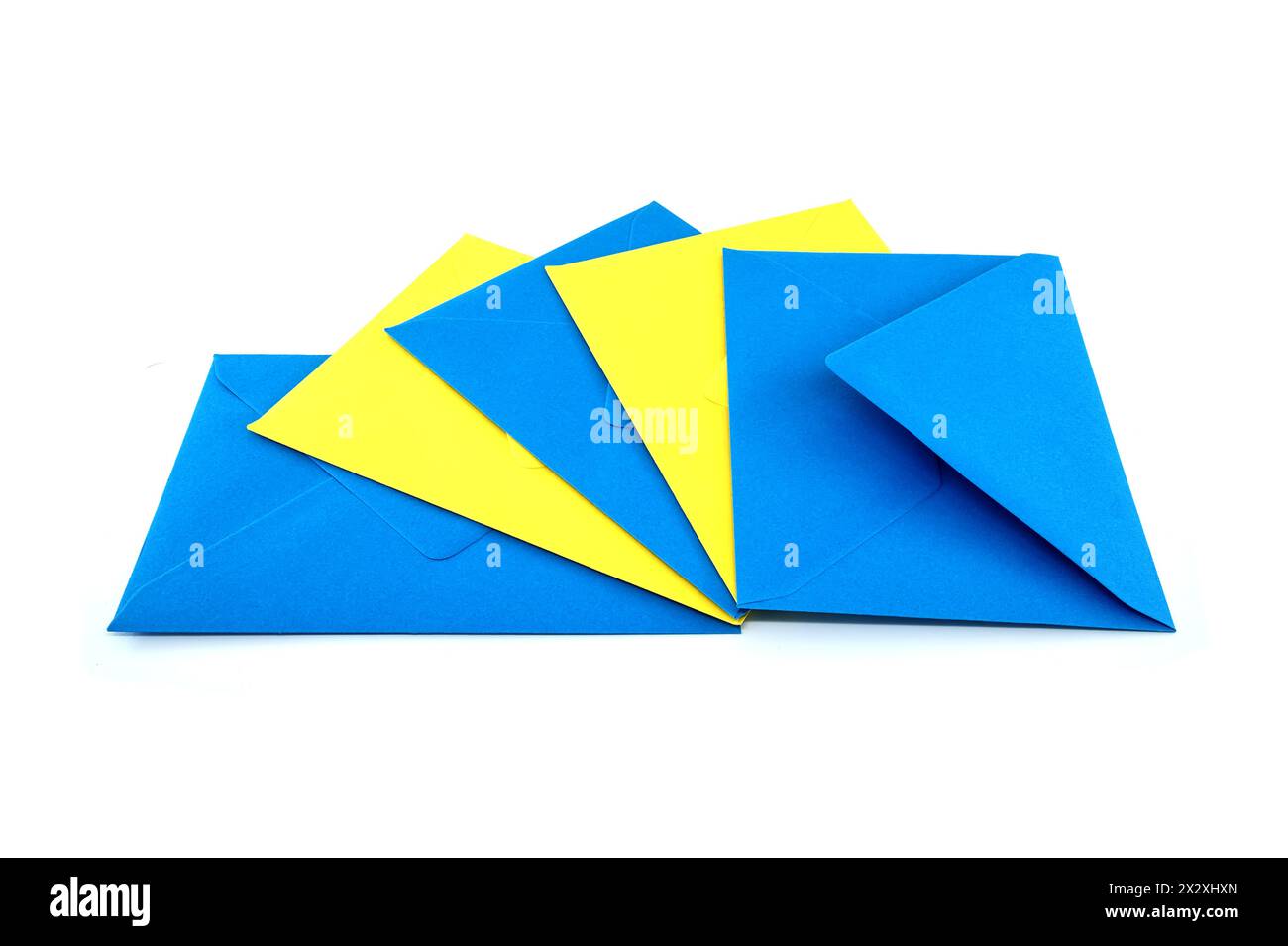 Collection of blue and yellow paper envelopes arranged against a white ...