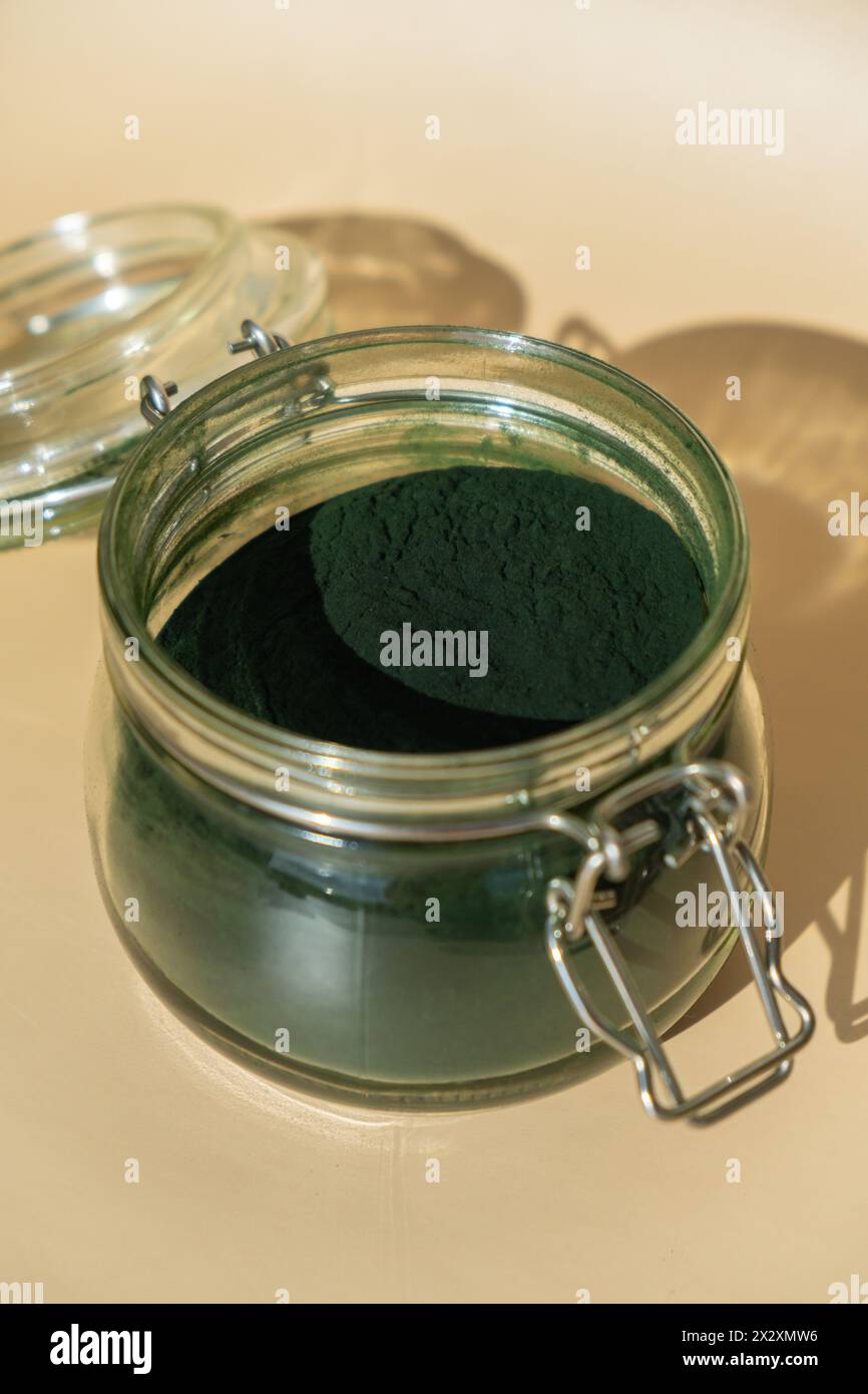 Organic blue-green algae spirulina powder food in glass jar. Health ...