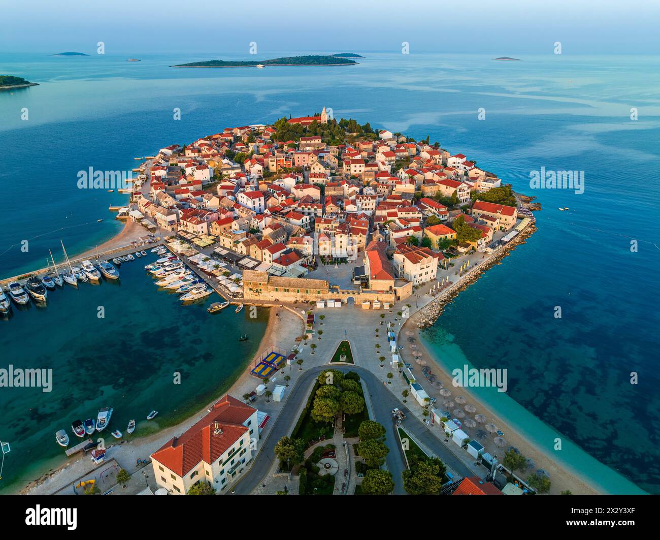 Primosten, Croatia - Aerial view of the old town of Primosten peninsula, St. George's Church on a sunny summer morning in Dalmatia, Croatia. Blue and Stock Photo