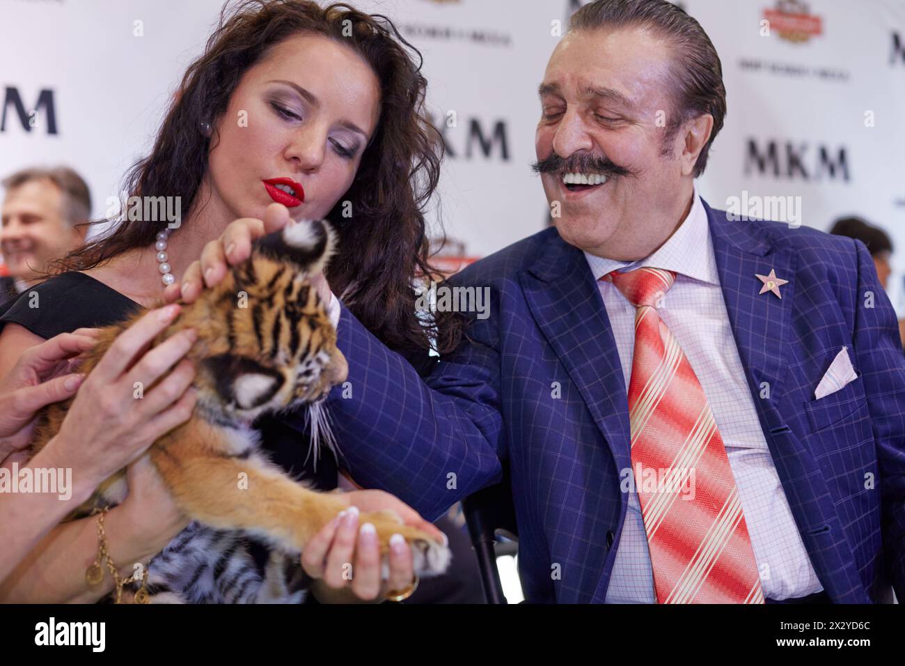 MOSCOW - OCT 22: Circus actress, tamer, animal trainer Karina Bagdasarova with tiger cub and american and russian singer Willy Tokarev at Phoney New Y Stock Photo