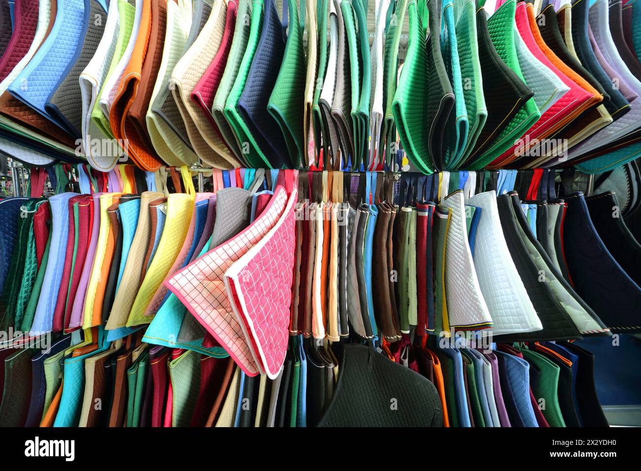 Colored mats under saddle horses Stock Photo - Alamy