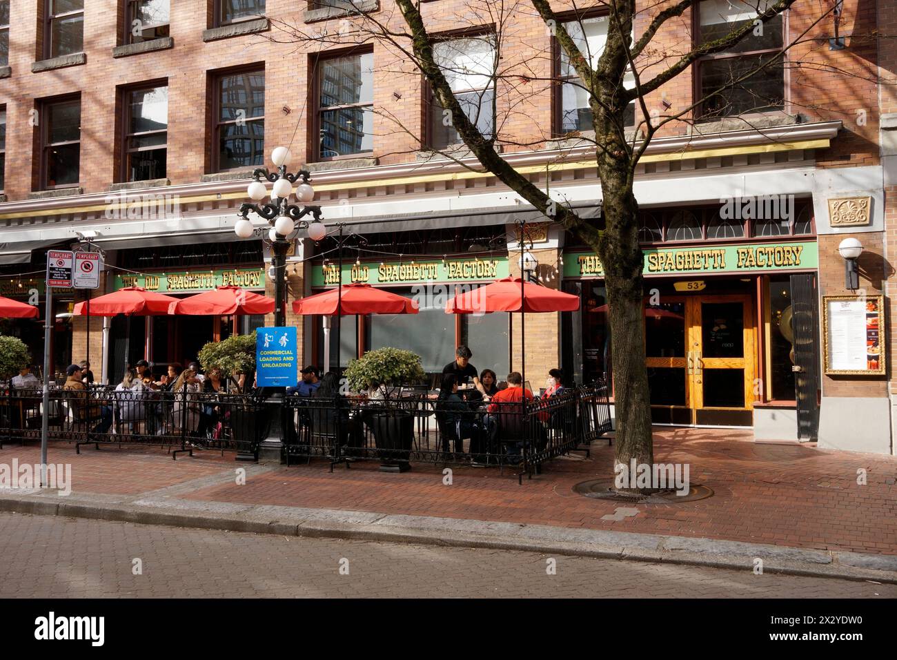 People sitting and dining outside The Old Spaghetti Factory restaurant in Gastown, Vancouver, BC, Canada Stock Photo