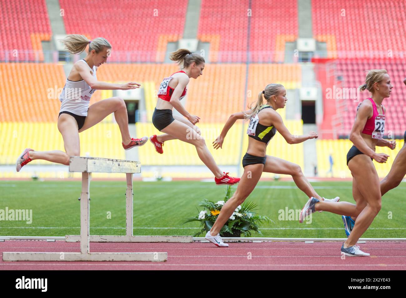 MOSCOW - JUN 11: Women each other overcome obstacle on International athletic competition Moscow Challenge on June 11, 2012 in Luzhniki, Moscow, Russi Stock Photo
