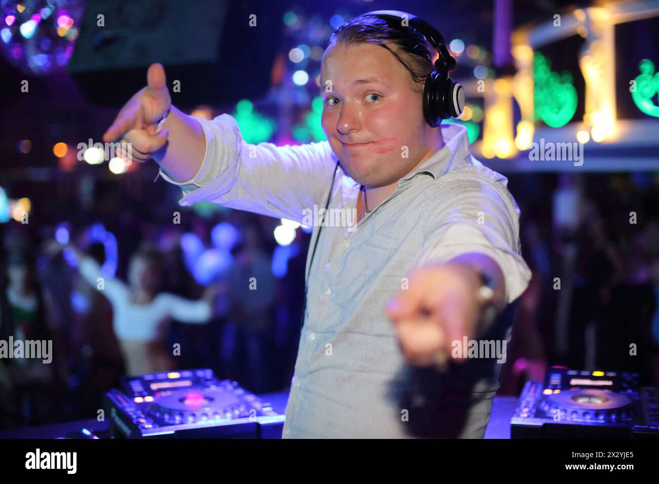 DJ in a club with a trace of lipstick on his face Stock Photo