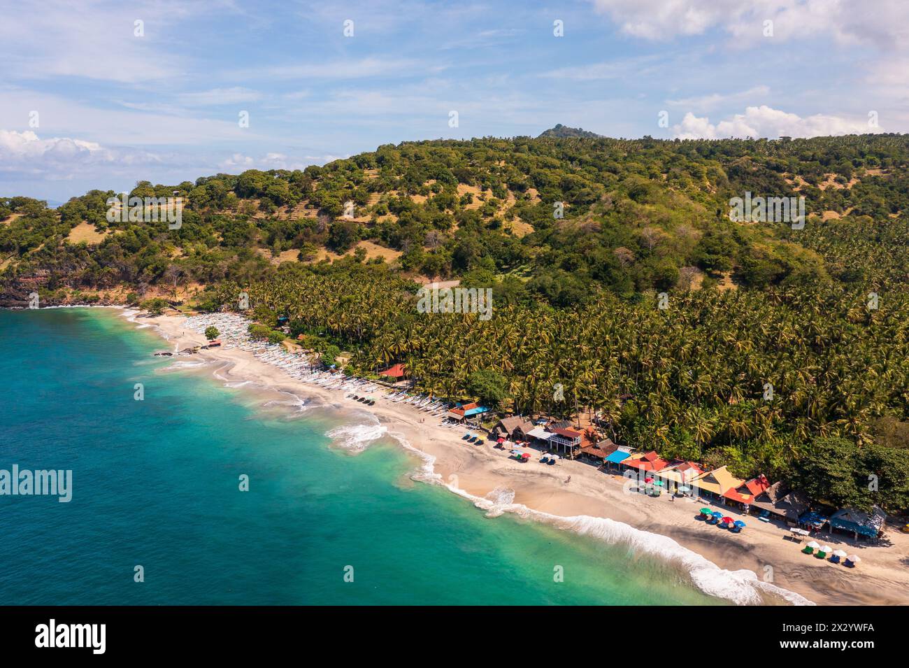 Bali, Indonesia: Aerial landscape of the Virgin beach near Amlapura and Candidasa in eastern Bali with a few drink and food stands. Stock Photo