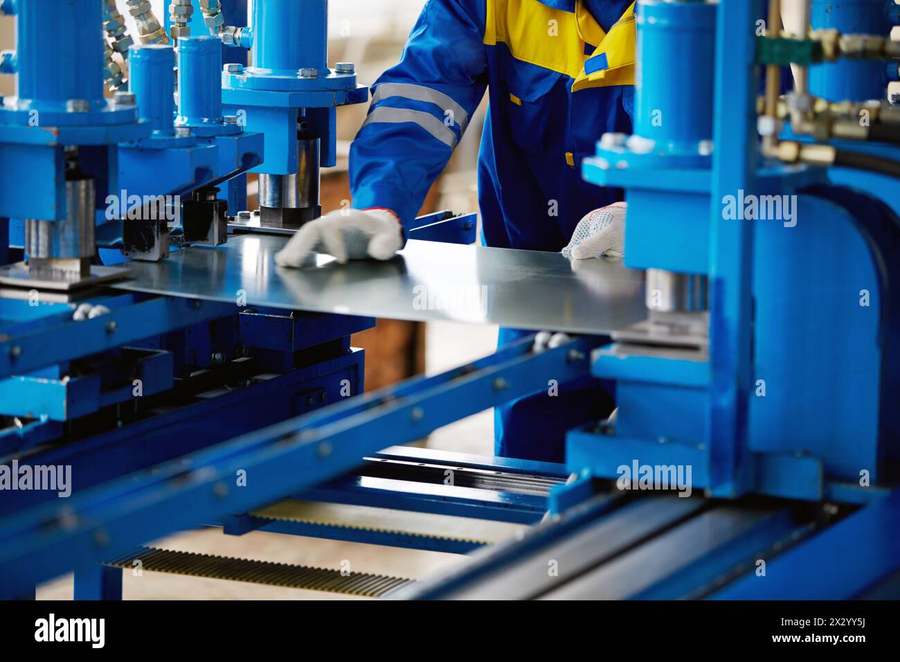 Sheet of metal and hands of worker who works on press stock photo alamy